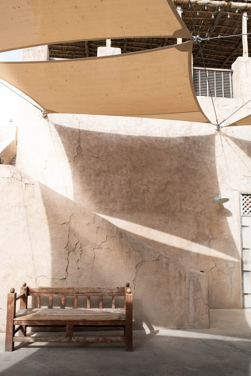 A shaded bench and heritage architecture in Al Fahidi, Dubai