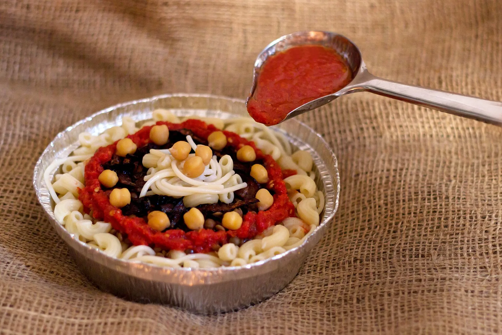 Plate of Egyptian koshary with its toppings