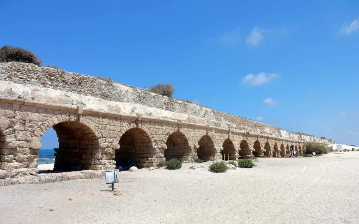 Ancient aqueduct arches beside the beach at Caesarea