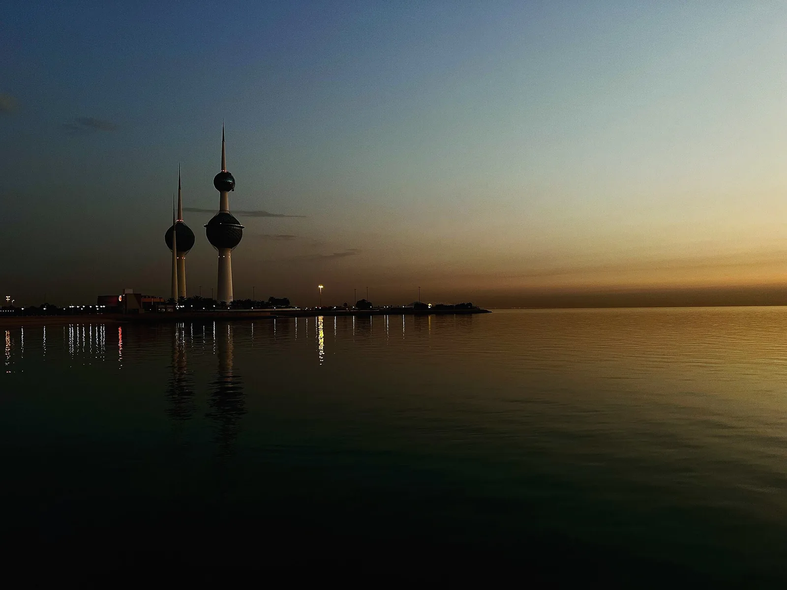 Kuwait Towers beside the water in low evening light