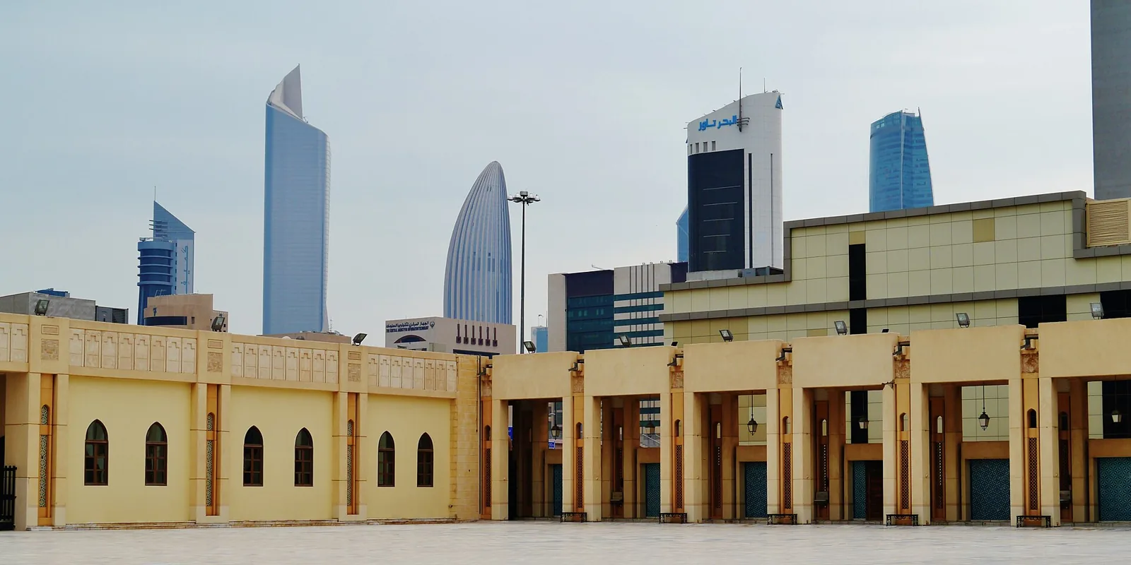 Grand Mosque courtyard and the surrounding Kuwait City skyline