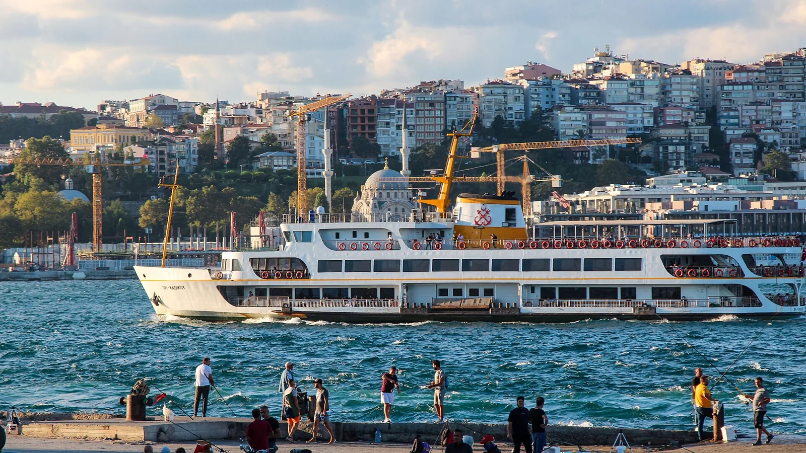 Ferry on the Bosphorus in front of Istanbul waterfront buildings